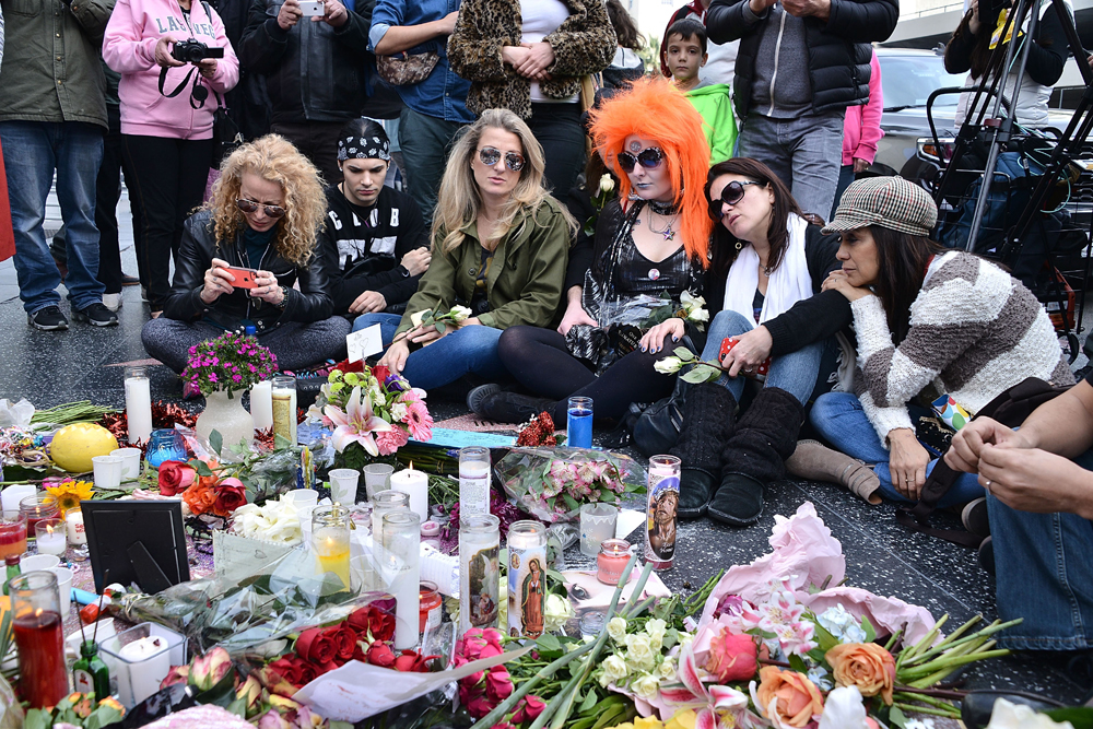 HOLLYWOOD, CA - JANUARY 11: People pay tribute at a memorial on David Bowie's star on The Hollywood Walk of Fame on January 11, 2016 in Hollywood, California. British music and fashion icon David Bowie died earlier January 10 at the age of 69 after a battle with cancer. Araya Diaz/Getty Images/AFP