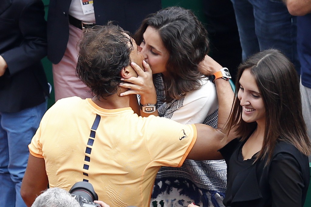 Spain's Rafael Nadal kisses his girlfriend Xisca Perello after winning against France's Gael Monfils in the final tennis match at the Monte-Carlo ATP Masters Series Tournament in Monaco on April 17, 2016. Nadal defeated Monfils 7-5, 5-7, 6-0 to win a record ninth title at the Monte Carlo Masters.  AFP PHOTO / VALERY HACHE / AFP PHOTO / VALERY HACHE